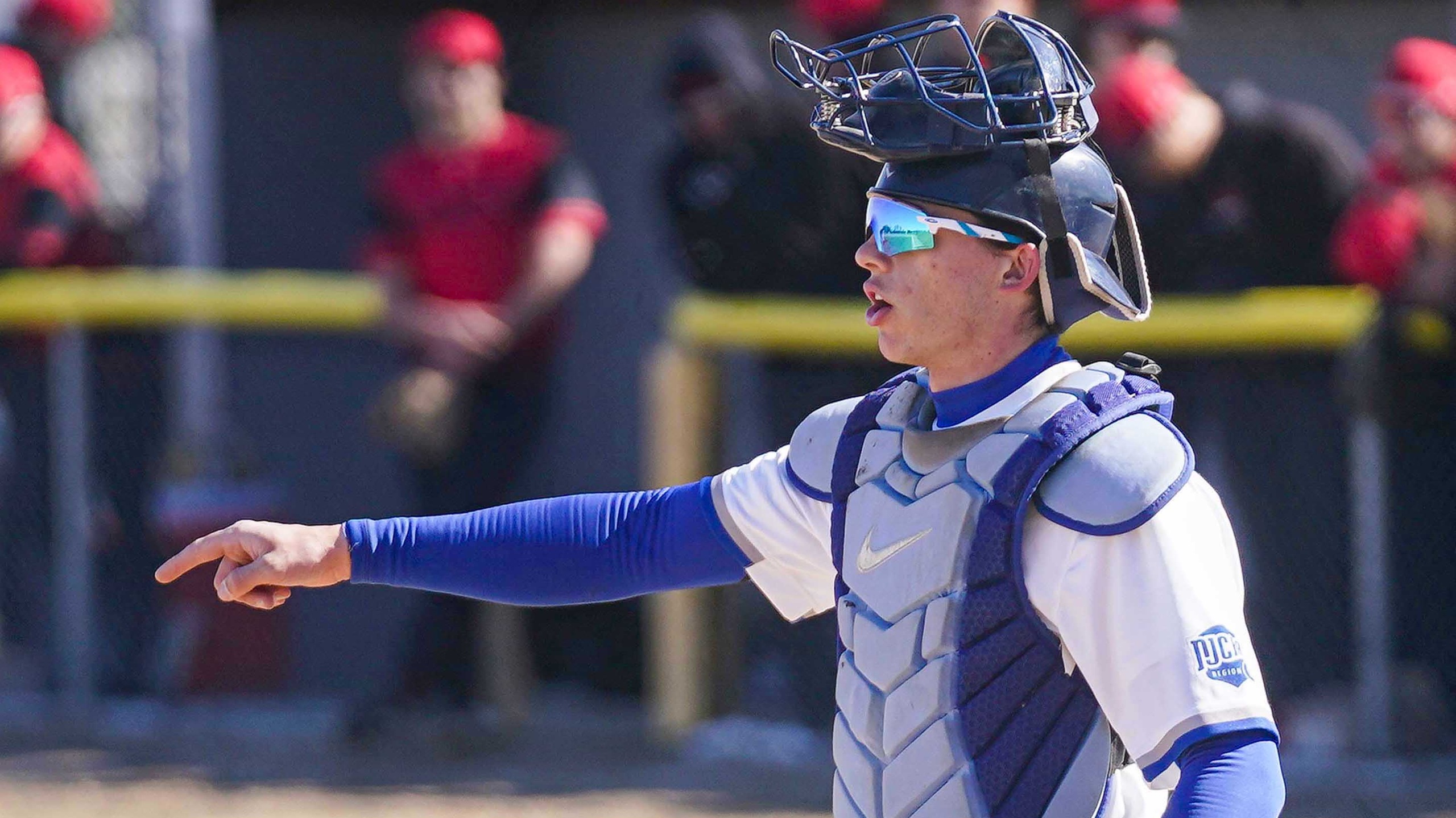 College catcher calling defensive alignment.