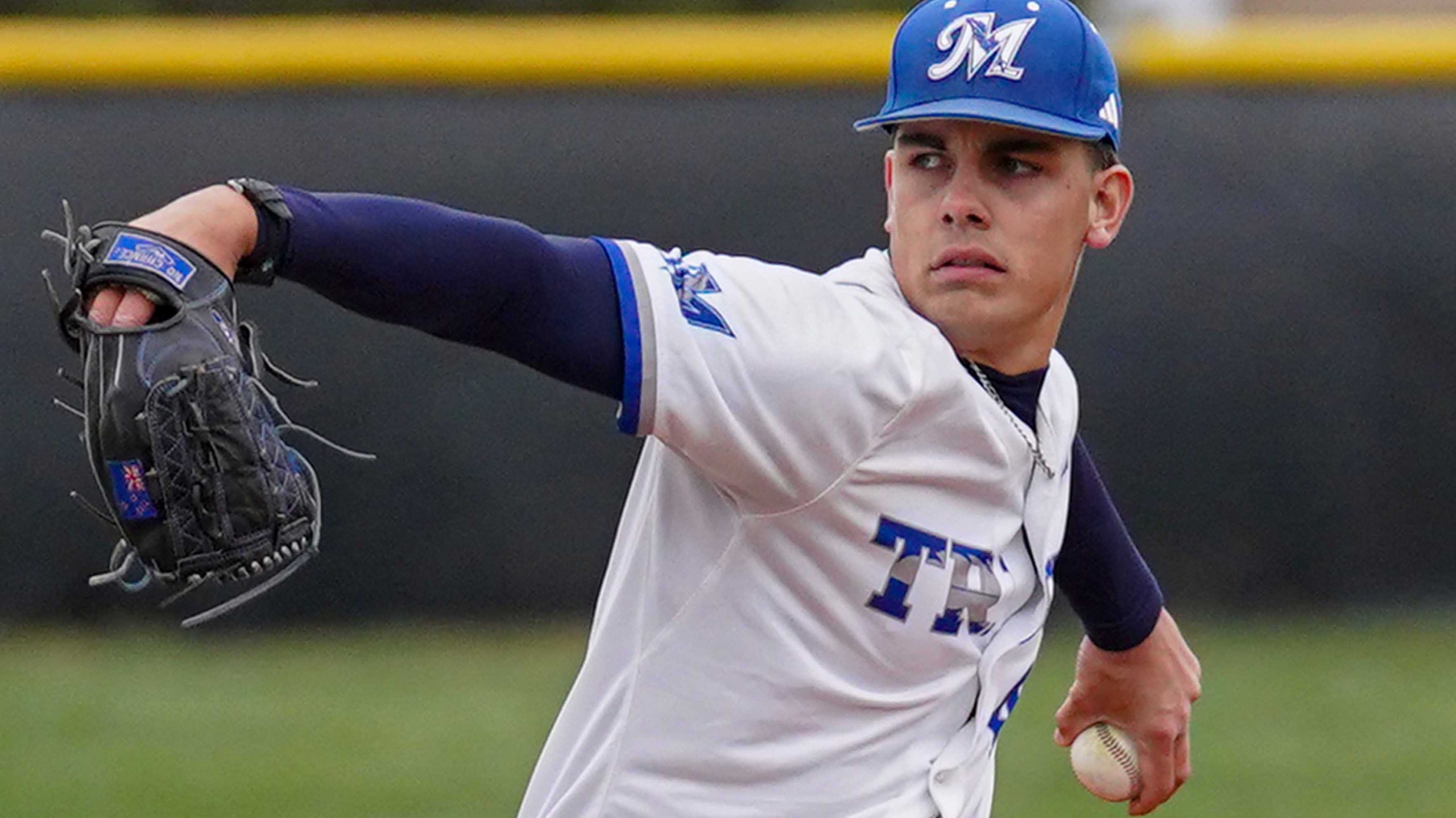 College baseball player pitching the ball.