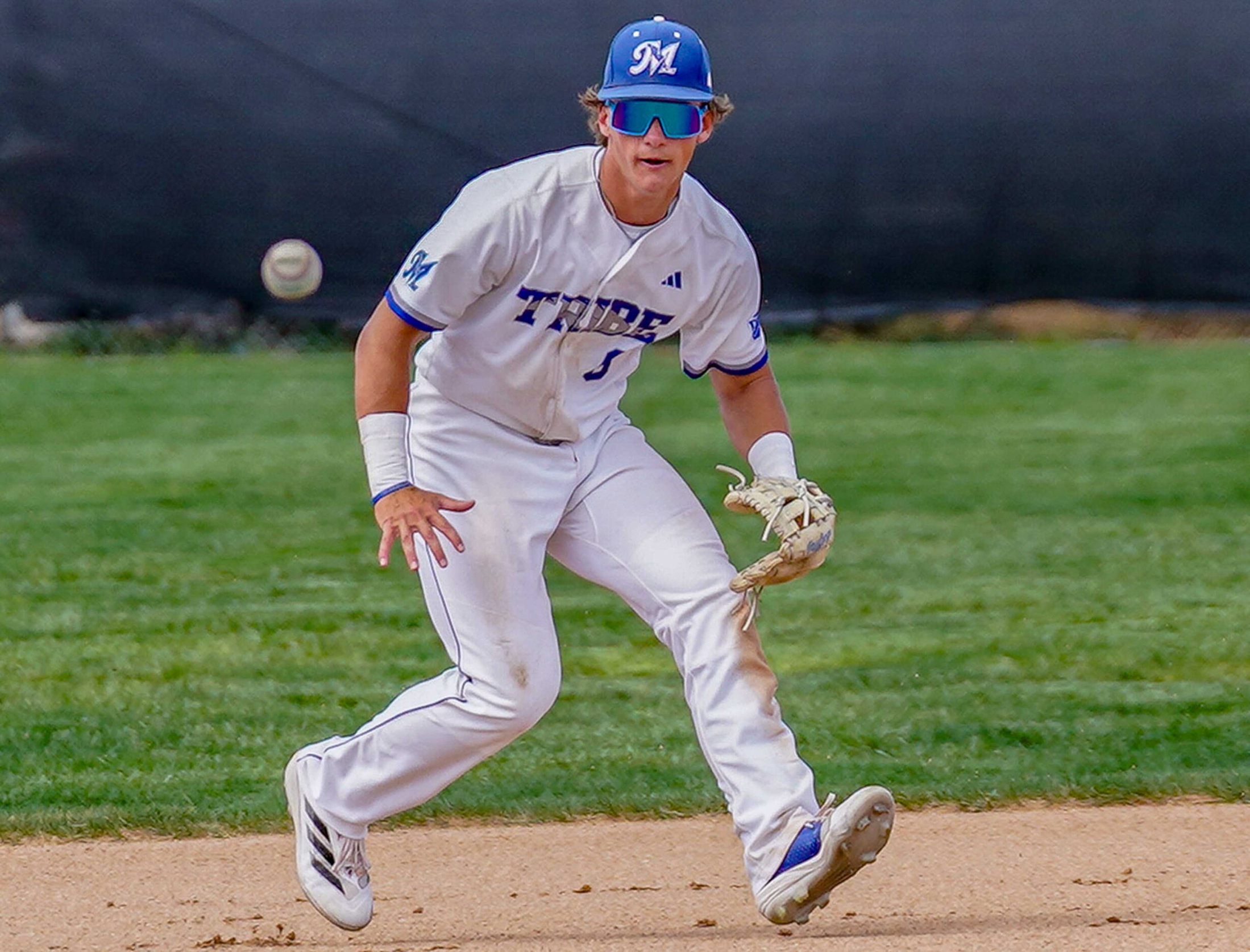 College baseball player fielding the ball.